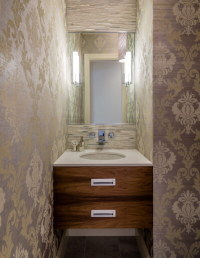 sink nook with modern style finishes, intricate wallpaper, and wall sconces