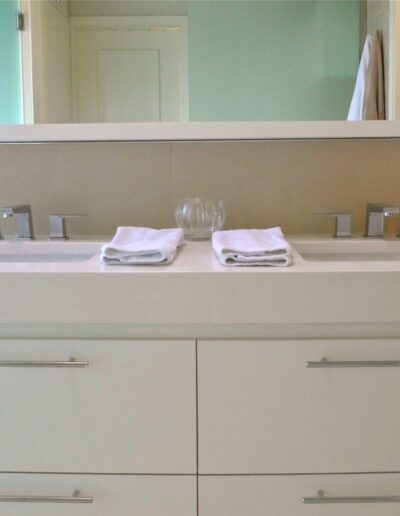all white bathroom with dual vanity undermount sinks