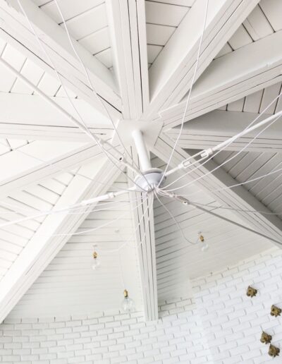beach-style white wood ceiling with beams and white ceiling light fixture