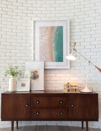 curved white brick wall with retro hutch and beachy decorations