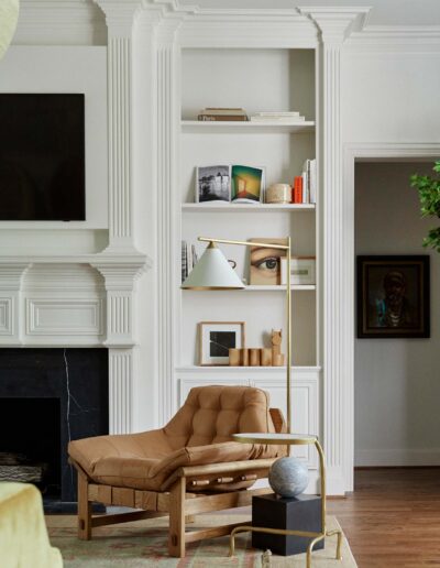 built-in shelving with lots of molding and a black fireplace