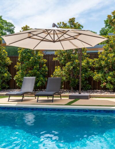 poolside lounge chairs with umbrellas