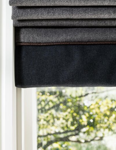 Quality gray roman curtains on window